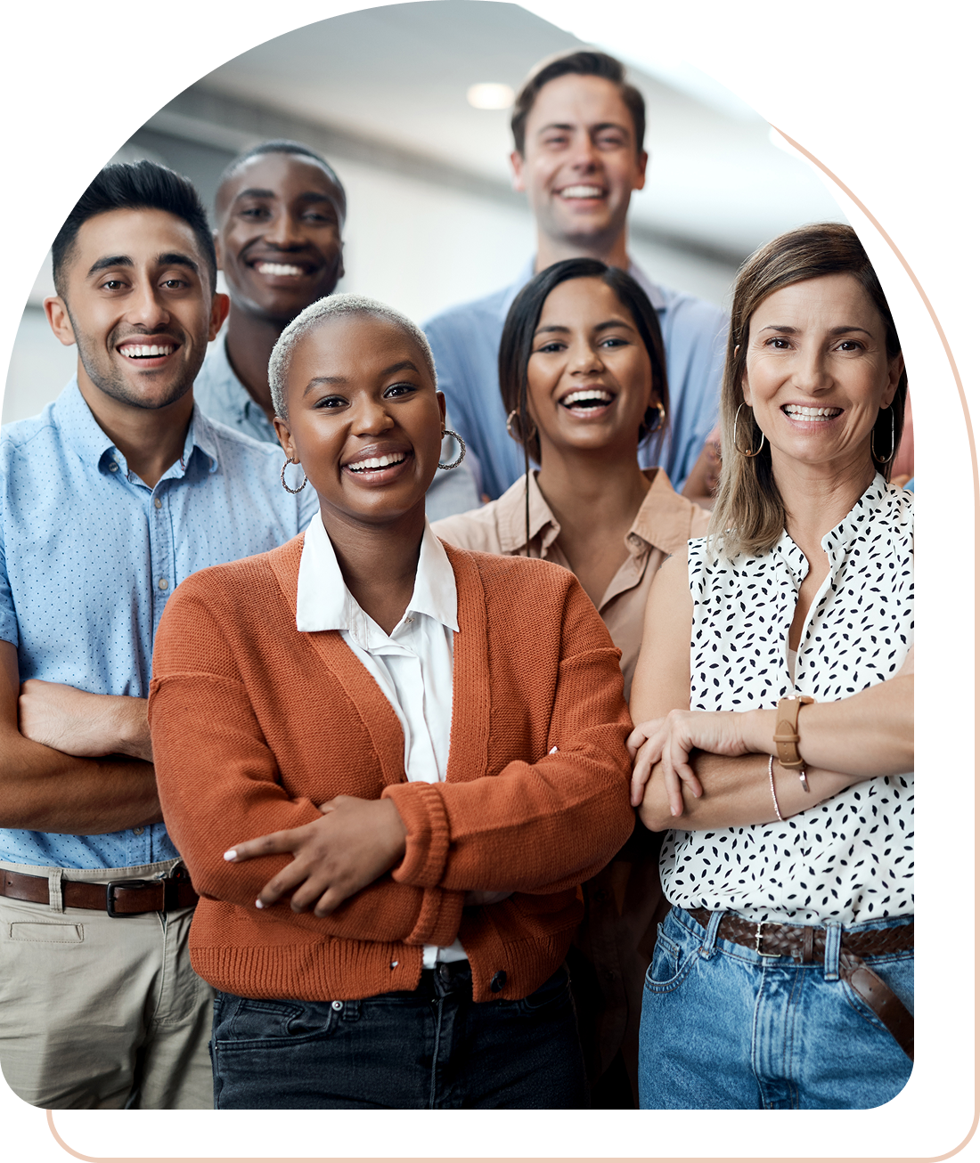 A diverse group of six smiling professionals posing confidently.